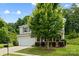 Traditional two-story home featuring a two-car garage, manicured lawn, and mature landscaping at 8400 Empress Ct, Charlotte, NC 28227