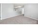 This hallway has neutral walls and plush carpet at 8400 Empress Ct, Charlotte, NC 28227