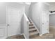 Hallway featuring hardwood style floors and staircase, with white painted trim and neutral walls at 8400 Empress Ct, Charlotte, NC 28227