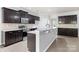 Charming kitchen features dark wood cabinetry and a granite-topped breakfast bar, stainless steel appliances at 8400 Empress Ct, Charlotte, NC 28227