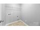 This is a laundry room with washer hookups, dryer hookups, and built in storage at 8400 Empress Ct, Charlotte, NC 28227