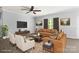 Cozy living room with comfortable seating, ceiling fan, large windows, and stylish decor at 8400 Empress Ct, Charlotte, NC 28227