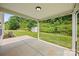 Covered patio overlooking a spacious backyard with lush greenery and a storage shed at 8400 Empress Ct, Charlotte, NC 28227