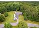 Aerial view of the home, featuring a driveway with parked vehicles and wooded surroundings at 8632 Island Point Rd, Sherrills Ford, NC 28673