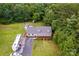 Aerial view showing a home, large yard, trailer, and surrounded by lush trees at 8632 Island Point Rd, Sherrills Ford, NC 28673