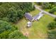 Aerial view of a property with a large lawn, accessory building, and wooded boundary at 8632 Island Point Rd, Sherrills Ford, NC 28673