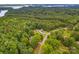 Expansive aerial view of a home nestled amongst lush greenery and bordering a serene lake at 8632 Island Point Rd, Sherrills Ford, NC 28673