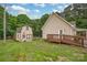 Backyard view of the home, a large yard and shed at 8632 Island Point Rd, Sherrills Ford, NC 28673