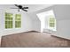 Bright bedroom with neutral carpet, a ceiling fan, and natural light from windows at 8632 Island Point Rd, Sherrills Ford, NC 28673