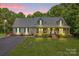 Charming ranch-style home featuring a welcoming front porch, lush lawn, and beautiful landscaping at 8632 Island Point Rd, Sherrills Ford, NC 28673