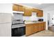 Functional kitchen with stainless steel appliances, wood cabinetry, and tile floors at 8632 Island Point Rd, Sherrills Ford, NC 28673
