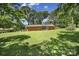 Expansive backyard showcasing lush greenery and the rear of the brick home at 967 Hilldale Dr, Lancaster, SC 29720