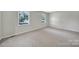 Spacious bedroom featuring neutral carpet and paint, with sun-filled windows at 967 Hilldale Dr, Lancaster, SC 29720