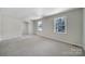 Bright bedroom with neutral carpet and two windows, offering ample natural light at 967 Hilldale Dr, Lancaster, SC 29720