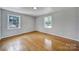 Bright bedroom with hardwood flooring, two windows, and neutral paint at 967 Hilldale Dr, Lancaster, SC 29720