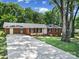 Charming brick ranch-style home with a well-manicured lawn and a long driveway at 967 Hilldale Dr, Lancaster, SC 29720