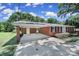 Side view of a well-maintained brick home showing the attached carport at 967 Hilldale Dr, Lancaster, SC 29720