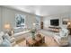Bright living room with neutral walls, large windows, and rustic wood coffee table at 967 Hilldale Dr, Lancaster, SC 29720