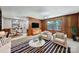 Cozy living room with wood paneling and neutral furniture, flowing into bright eat-in kitchen at 967 Hilldale Dr, Lancaster, SC 29720