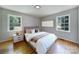 Bedroom featuring hardwood floors, two windows, and a decorative painting above the headboard at 967 Hilldale Dr, Lancaster, SC 29720