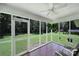 Relaxing screened porch with tile floor, ceiling fan, and serene backyard views at 967 Hilldale Dr, Lancaster, SC 29720