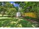 Backyard storage shed with a white exterior and a yellow privacy fence at 967 Hilldale Dr, Lancaster, SC 29720