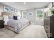 Serene bedroom with large windows, plush carpet, and a stylish bed with a striped duvet at 10127 Florentine Way, Charlotte, NC 28214