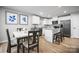 Open dining area with a modern table set and natural light, adjacent to the kitchen at 10127 Florentine Way, Charlotte, NC 28214