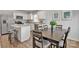 Open floor plan with kitchen, island, stainless appliances, dining area with seating for six at 10127 Florentine Way, Charlotte, NC 28214