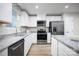 Modern kitchen with stainless steel appliances, granite countertops, and white cabinetry at 10127 Florentine Way, Charlotte, NC 28214