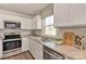 Bright kitchen featuring white cabinets, stainless steel appliances, and a granite countertop at 10127 Florentine Way, Charlotte, NC 28214