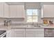 Bright kitchen featuring white cabinets, stainless steel appliances, and a granite countertop at 10127 Florentine Way, Charlotte, NC 28214
