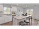 Open kitchen with island, granite countertops, stainless appliances, and a dining area at 10127 Florentine Way, Charlotte, NC 28214
