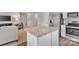 Open-concept living area connected to kitchen with island featuring stainless steel appliances at 10127 Florentine Way, Charlotte, NC 28214