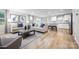 Spacious living room featuring vinyl floors, modern sofas, and decor with access to the kitchen at 10127 Florentine Way, Charlotte, NC 28214