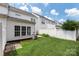 Backyard view featuring a small patio, green grass and an air conditioning unit at 10225 Alexander Martin Ave, Charlotte, NC 28277