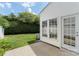 Backyard view featuring a small patio, green grass and an air conditioning unit at 10225 Alexander Martin Ave, Charlotte, NC 28277