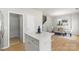 Open floor plan with dining area featuring contemporary chandelier and dining set, next to the kitchen at 10225 Alexander Martin Ave, Charlotte, NC 28277