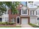 Charming brick and white-paneled townhome with a one-car garage and black shutters at 10225 Alexander Martin Ave, Charlotte, NC 28277