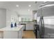 Bright kitchen features stainless steel appliances, an island with white countertops, and an open floor plan at 10225 Alexander Martin Ave, Charlotte, NC 28277