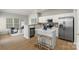 Stylish kitchen featuring stainless appliances, a breakfast bar, and an open concept to living area at 10225 Alexander Martin Ave, Charlotte, NC 28277