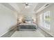 A bedroom boasting a tray ceiling, carpeted floor, and a large window at 10225 Alexander Martin Ave, Charlotte, NC 28277
