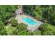 Overhead view of the community pool and deck with chairs surrounded by mature trees at 10225 Alexander Martin Ave, Charlotte, NC 28277