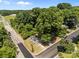 Aerial view of a charming home surrounded by lush greenery, mature trees and nestled in a tranquil neighborhood at 103 Garfield Ave, Albemarle, NC 28001