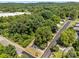 Aerial view of a charming home surrounded by lush greenery, mature trees and nestled in a tranquil neighborhood at 103 Garfield Ave, Albemarle, NC 28001