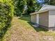 View of a spacious backyard with well-maintained lawn and a door with access to the house at 103 Garfield Ave, Albemarle, NC 28001