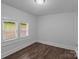 Cozy bedroom featuring two windows with outside views and dark wood-look flooring at 103 Garfield Ave, Albemarle, NC 28001