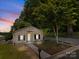 Inviting single-story home with a well-maintained yard, sidewalk and gravel driveway surrounded by mature trees at 103 Garfield Ave, Albemarle, NC 28001
