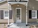Charming front entrance features a glass panel door flanked by black shutters and white trim at 103 Garfield Ave, Albemarle, NC 28001