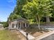Charming single story home with tan siding, black shutters, and a manicured lawn with mature trees at 103 Garfield Ave, Albemarle, NC 28001